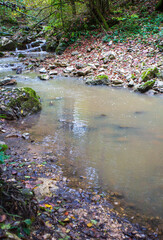 the spring period in nature, a shallow riverbed with a small flow of water