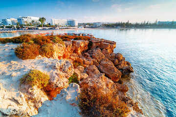 Sunrise on the famous Nissi Beach in Ayia Napa, Cyprus. Rocky coast in the morning. Seaside resort...