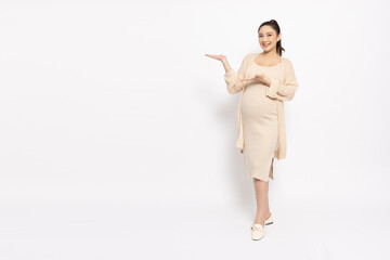 Happy Asian Pregnant woman standing smile and present to copy space isolated on white background,...