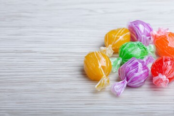 Colorful Wrapped Hard Candies on Wood: A Sweet and Vibrant Still Life