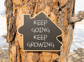 Keep going and growing symbol. Concept words phrase Keep going keep growing on beautiful black...