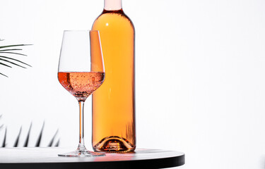 Refreshing rose pink wine served in a glass alongside an elegant bottle on a modern table