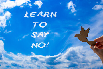 Learn to say no symbol. Concept words phrase Learn to say no on beautiful blue sky. Businessman's...