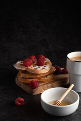 Delicious waffles with fresh raspberries and honey