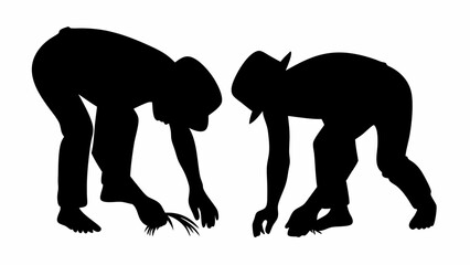 Silhouette of two people bending over and appearing to be picking something up from the ground outdoors