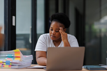 Fototapeta premium Migraine, business and black woman in office with laptop for editing report, burnout or project deadline. Fatigue, stress and female employee with eyes closed for headache, anxiety or overworked 
