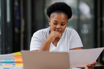 Overworked African American business woman or female office worker suffering from neck pain after...