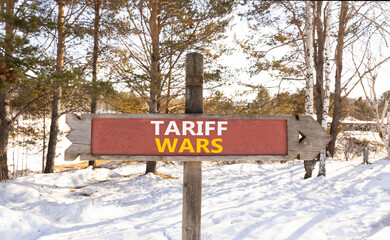 Trade tariff wars symbol. Concept word Tariff wars on beautiful wooden road sign. Beautiful snow...