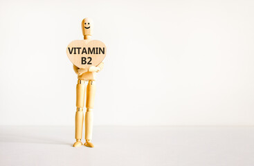 Vitamin B2 riboflavin symbol. Concept words Vitamin B2 on beautiful wooden heart. Doctor's model....