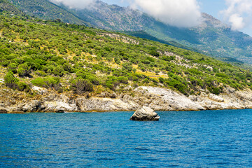 Icarus or Ikarus rock mythological landmark with seagull on coast of Ikaria, Greece longevity blue zone Aegean island, view from Icarian sea