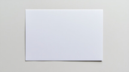 Fototapeta premium Minimalist Presentation: Blank white rectangular sheet against a soft neutral background, offering a clean and versatile space for design projects.