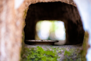 Nara, Japan Kasuga taisha shrine stone lanterns closeup of one lamp texture inside hole with candle light and green moss