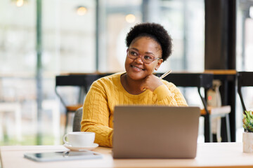 Busy African American business woman using laptop working in corporate executive at office....