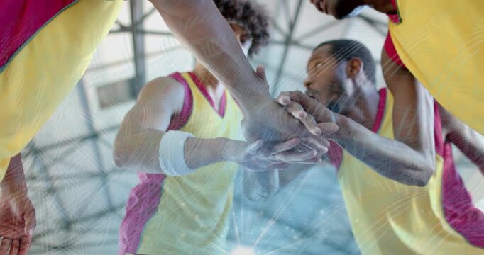 Upon game tipoff, basketball players stacking hands with animated energy rings highlighting unity