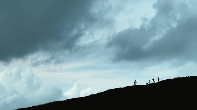 Wide cinematic shot of a family as tiny silhouettes walking along a high hill ridge beneath a vast, cloudy sky, emphasizing scale, journey, resilience, and the immensity of the world around them.
