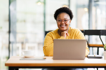 Fototapeta premium Happy African American Businesswoman Using Laptop At Workplace Modern Office. Copy Space 