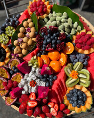 Colorful assorted fruits beautifully arranged on platter.