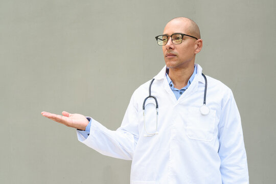 Hispanic Male Doctor in Lab Coat with Stethoscope on Plain Background