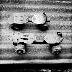 Pair of antique metal roller-skates sitting on a sheet of corrugated iron