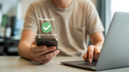 Person using phone with thank you message and laptop for online payment confirmation process