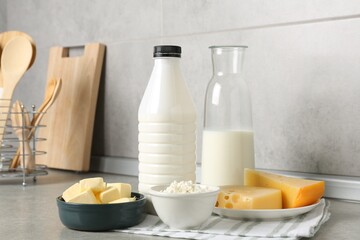 Different dairy products on gray textured table in kitchen