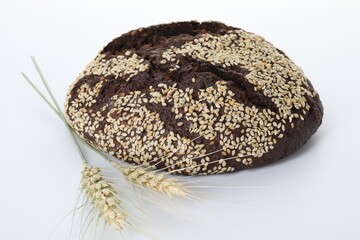 Fresh rye bread with seeds and spikes isolated on white