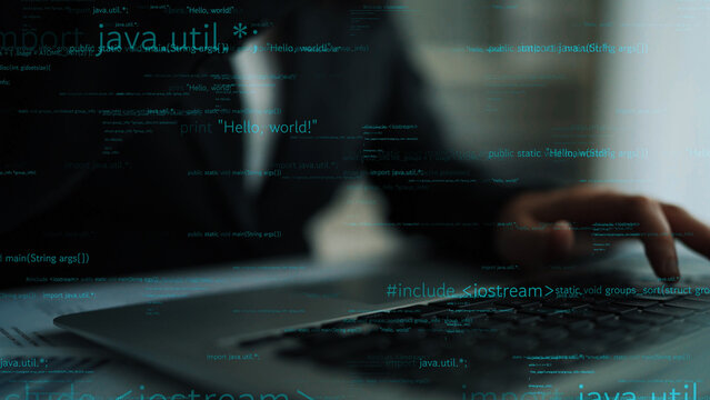 A focused view of a blurred business individual typing on a laptop, with overlays of programming code, capturing the essence of modern technology and digital work environments. Xenic