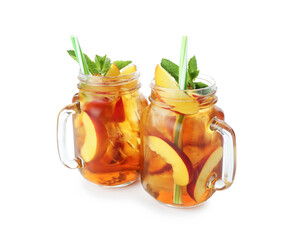 Refreshing iced peach tea with mint in mason jars isolated on white
