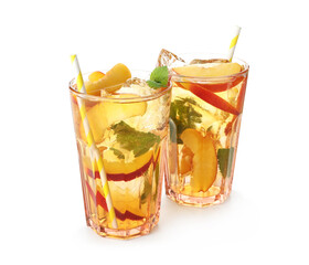 Refreshing iced peach tea in glasses isolated on white