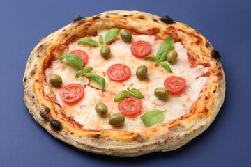 Delicious pizza with tomatoes, basil and olives on blue background, closeup