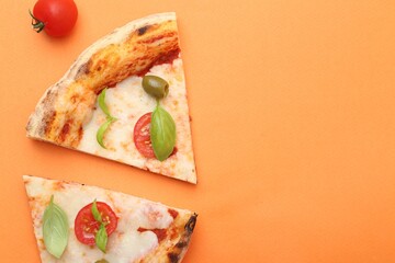 Slices of delicious pizza and tomato on orange background, flat lay. Space for text