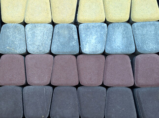 Colorful assortment of interlocking concrete pavers in rectangular pattern