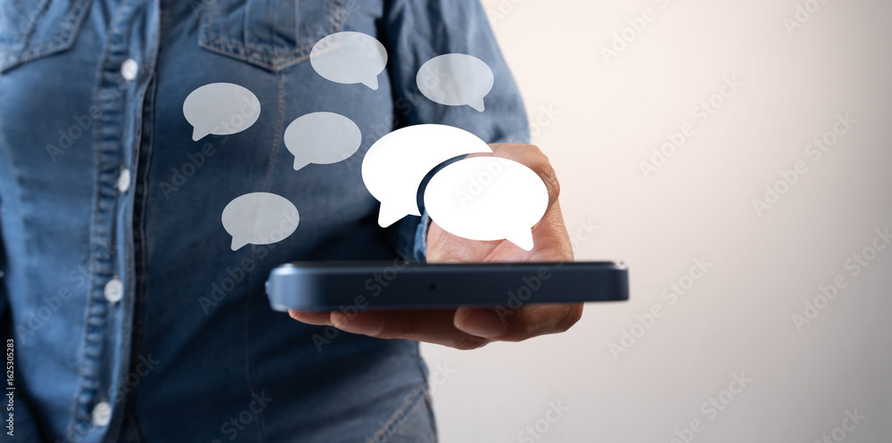 Poster close-up of a person holding a cell phone with floating chat icons around it