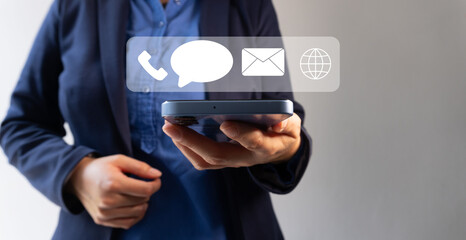 Person with a cell phone and contact icons floating on top