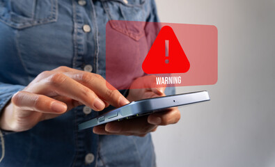Person with a cell phone and a Warning sign on a virtual screen