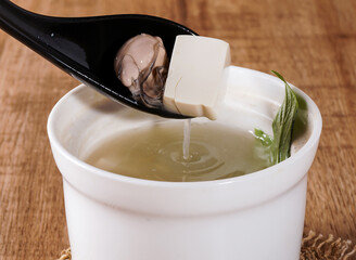 Anping oyster soup with tofu and greens in broth close up side view of traditional Taiwanese seafood dish
