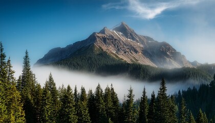 majestic mountain peak surrounded by mist and evergreen trees creating serene and tranquil landscape