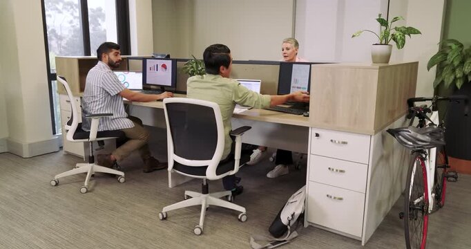 Mid adult Asian man pausing typing on laptop, sorting papers and packing bag before leaving office