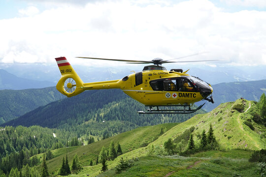 Christophorus 14 Eurocopter EC 135 operated by Austrian Red Cross. The yellow helicopter is used for mountain rescue in the high Alps. Near Dachstein massif, Styria, Austria, Europe.