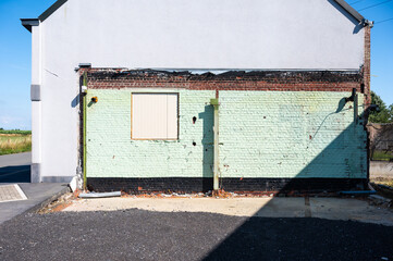 Green brick stone wall, partially worn down in Zonnebeke, West Flanders, Belgium