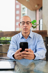 Man Texting on Mobile Phone Outdoors in Urban Area