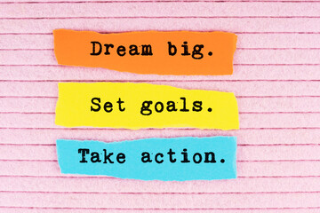 Torn paper with quotes dream big. Set goals. Take action on pink background