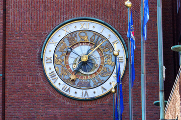 Astronomical clock on Oslo City Hall brick facade