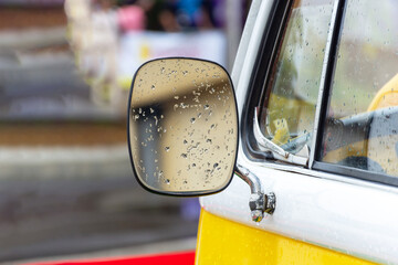 Close-up of Rain-Covered Side Mirror of a Classic Van.