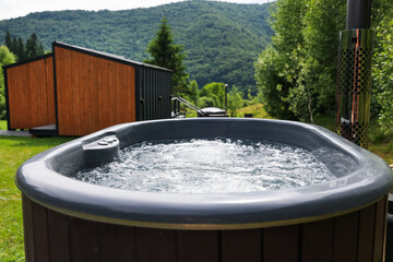 Tub with hot water at luxury resort in mountains, closeup
