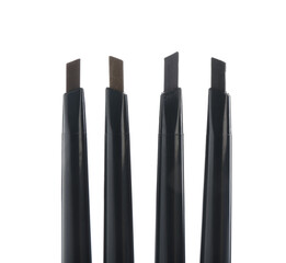 Many twist up eyebrow pencils isolated on white, top view