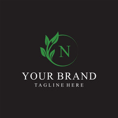 Initial letter N green leaves organic natural logo design, cosmetics and beauty vector icon concept