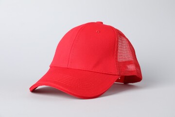 One red baseball cap on grey background, closeup. Mockup for design