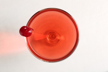 Tasty cherry cocktail on white table, top view