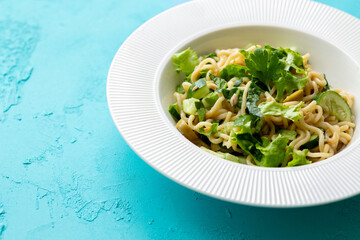 Asian noodle salad in white plate in close-up